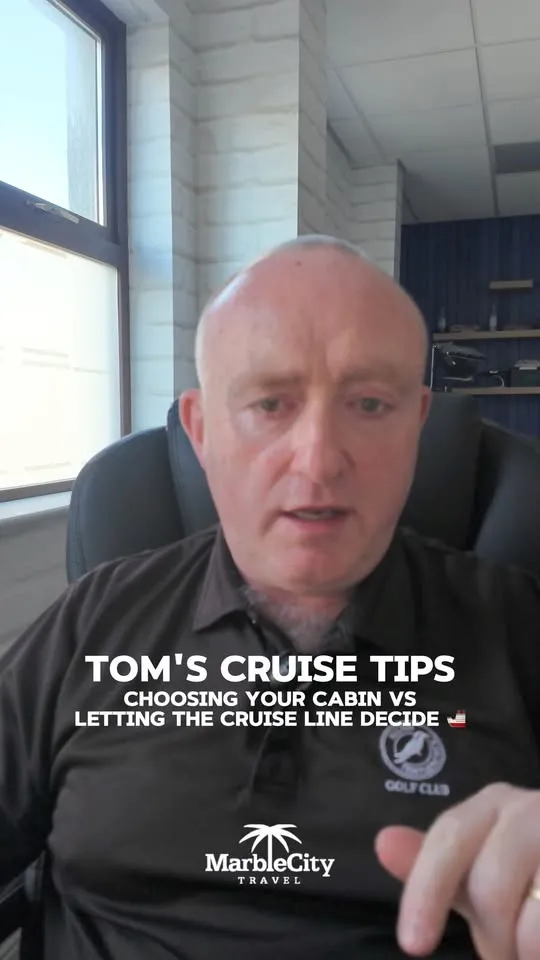 Tom Britton at his desk, filming a cruise tip